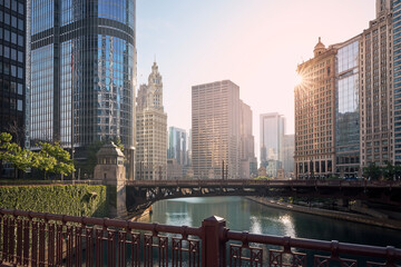 Bridges over Chicago River amidst skyscrapers. Urban skyline at beautiful sunrise. .