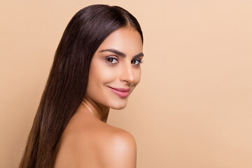 Fototapeta premium Profile side view portrait of attractive cheery delicate girl soft smooth skin copy space isolated over beige pastel color background