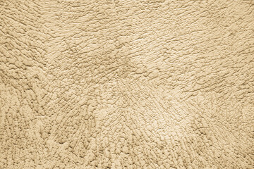Beige background of the plastered wall. Close up.