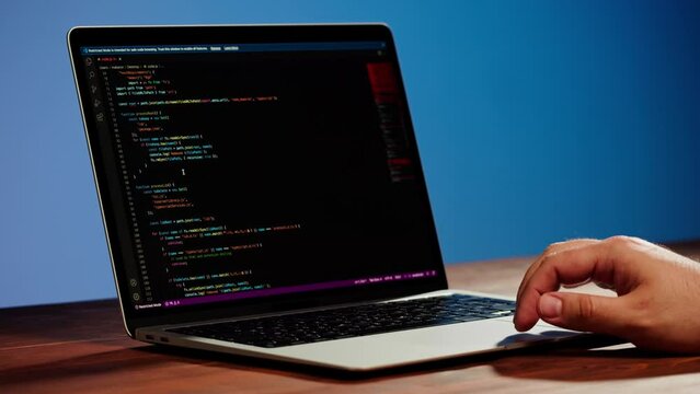 Programmer using laptop. Program code and script data on the screen close-up. Hacker attack. 