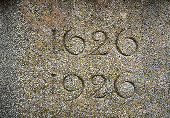tricentennial stone marker 1626-1926. High-quality, close-up image of the dates that commemorate a...