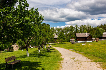 Skansen with wooden village houses near Sara Lubovna Castle in Slovakia at summer