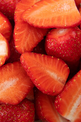 A lot of red ripe strawberries in a cut close-up.