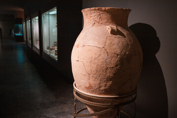 Classic illuminated Greek amphora for transporting and storing wine and olive oil - obrazy, fototapety, plakaty