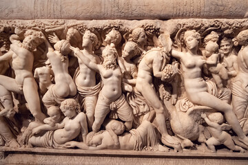 Bas-relief on the sarcophagus depicting a bacchanal led by the god of fun and wine - Dionysus