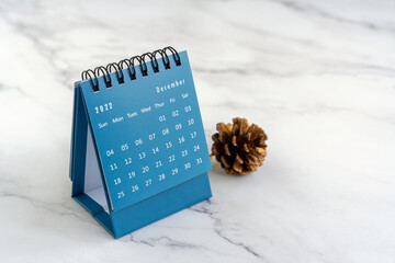 December 2022 desk calendar with pine cone