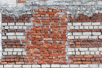 Red brick wall, old brick, grunge texture background. A wall with a walled-up window opening.