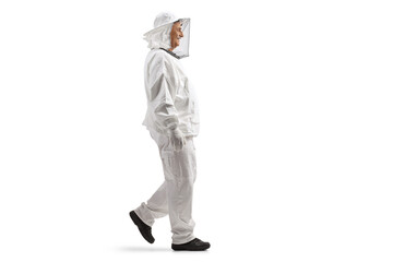 Full length profile shot of a male bee keeper in a uniform walking