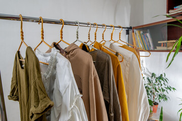 Second-hand clothes  on the rail. The concept of sustainable economic life