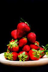 Fresh strawberries on black background
