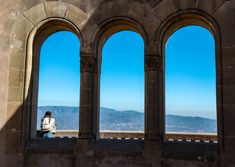 Outdoor Window with One Person in Montserrat. Girl Traveler Enjoys Scenic Views in Catalonia.