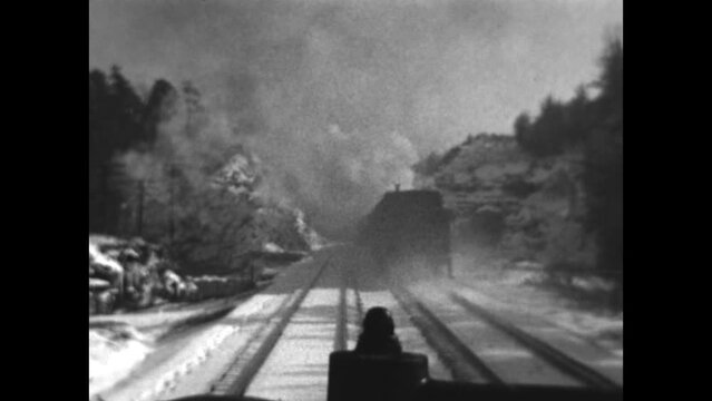 Train Traveling in Winter 1933 - A train travels across a snow covered landscape in 1933.