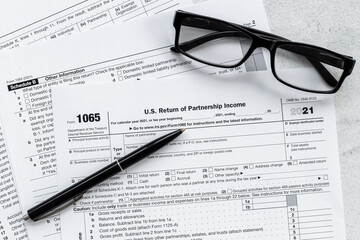 Businessman table with US tax form and pen. Culculating and payment of taxes