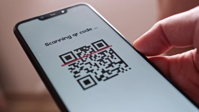 Wireless Electronic Payment Scanner with QR Code or Bar Code Technology. Modern Cashless Money Transfer Online Around the World. Scanning QR Code with Smartphone. Indoor. Closeup.
