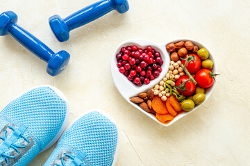Food for heart health with sports fitness equipment. Healthy nutrition eating