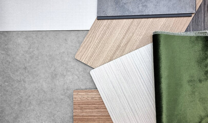 close up, combination of interior material samples containg green velvet fabric, white fabric laminateds, oak wood veneers and concrete vinyl flooring. interior mood and tone board for presentation.