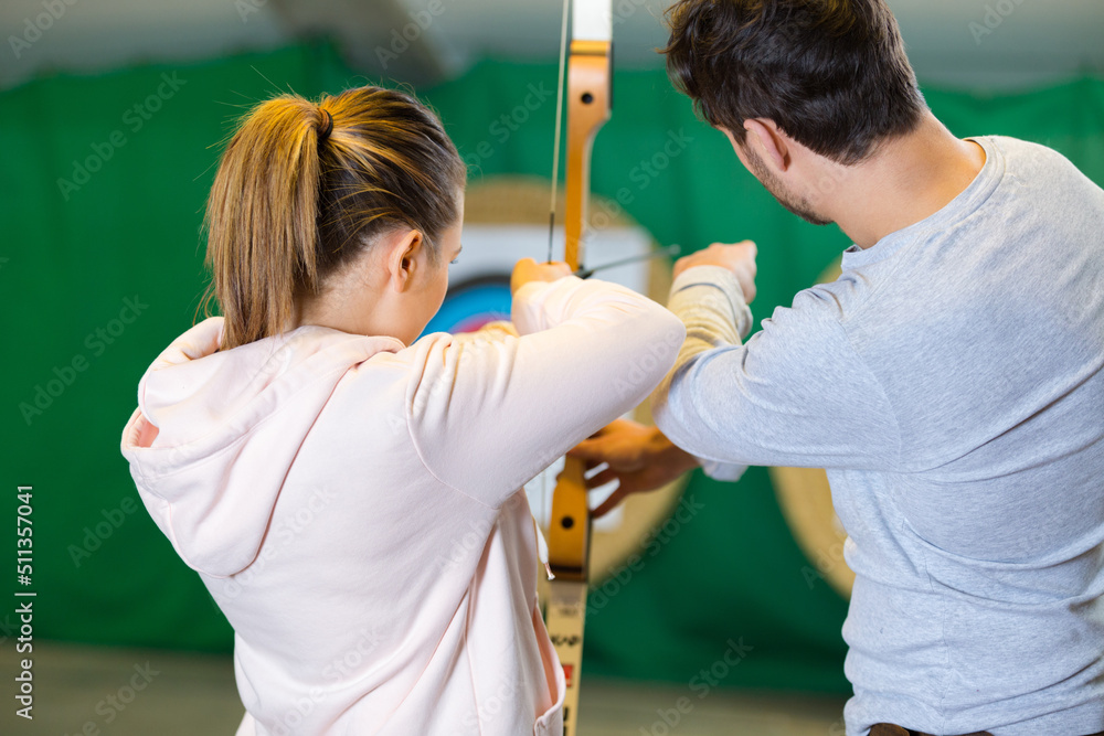 Wall mural portrait of people practicing indoor archery