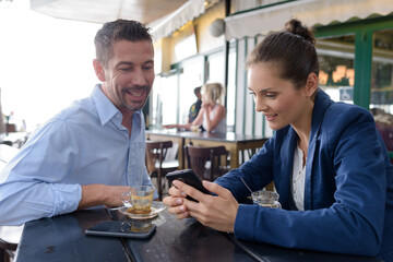 successful man and woman barista in restaurant