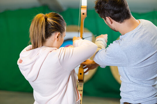 Portrait Of People Practicing Indoor Archery