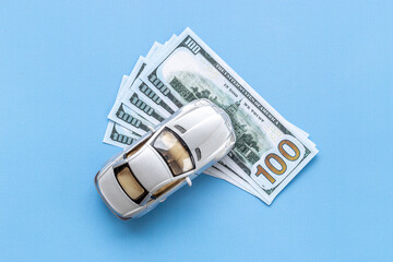 Saving money to buy a car. Toy car with money cash