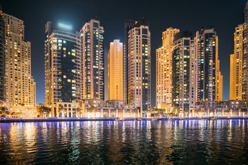 Fototapeta na wymiar Night view of high-rise buildings of residential district in Dubai Marina. Dubai Marina Towers. Dubai Marina Skyline Background. Holidays In United Arab Emirates. Vacation In UAE. Night view of high