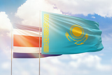 Sunny blue sky and flags of kazakhstan and costa rica