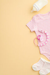 Baby accessories concept. Top view vertical photo of infant clothes pink bodysuit tiny socks milk...