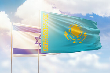 Sunny blue sky and flags of kazakhstan and israel