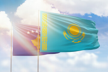Sunny blue sky and flags of kazakhstan and kosovo