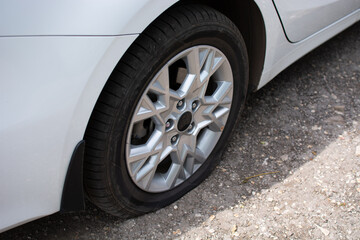 Flat tire on a white car