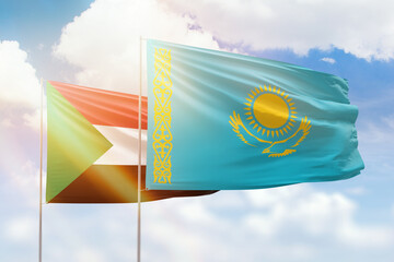 Sunny blue sky and flags of kazakhstan and sudan