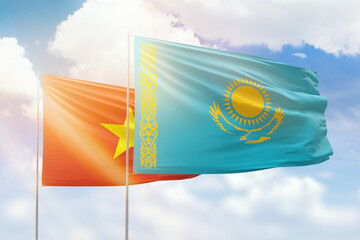 Sunny blue sky and flags of kazakhstan and vietnam - obrazy, fototapety, plakaty