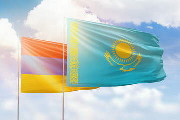 Sunny blue sky and flags of kazakhstan and armenia