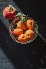 Fresh juicy orange apricots in a plate, half an apricot, apricots on the table, summer fruits and berries, vitamins and healthy nutrition
