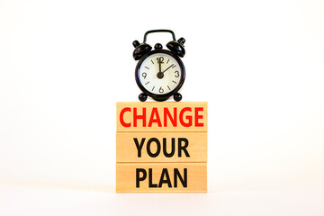 Change your plan symbol. Concept words Change your plan on wooden blocks on a beautiful white table white background. Black alarm clock. Business, finacial and change your plan concept. Copy space.
