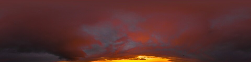 Dramatic red burning dark sunset sky panorama. Hdr seamless spherical equirectangular 360 panorama. Sky dome or zenith for 3D visualization and sky replacement for aerial drone 360 panoramas.