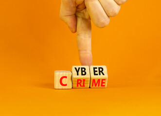 Cyber crime symbol. Concept words Cyber crime on wooden cubes. Businessman hand. Beautiful orange table orange background. Business and cyber crime concept. Copy space.