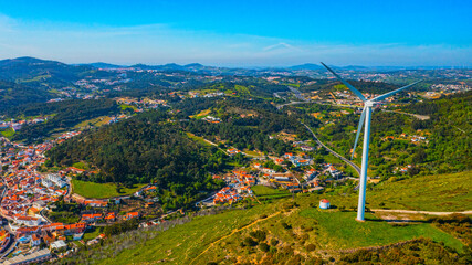 Wind turbine on the background of a small European city, a close-up view. The concept of clean Renewable energy.