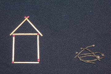 Matches in the form of a house on a dark cloth. Fire safety in the house