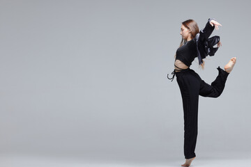 Beautiful young modern dancer or fitness dancer on a white isolated background