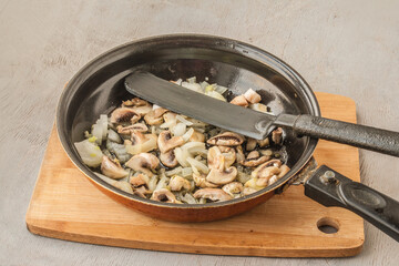 Pasta, mushrooms, onion cheese in a pan