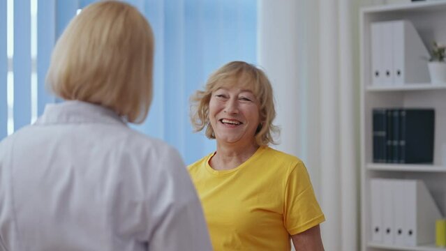 Patient and her rehabilitation therapist finishing session, giving high fives