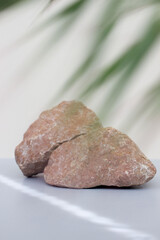 Empty natural stone podium on gray blue background, vertical photo