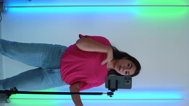 Vertical shoot. Teenager girl dancing, when making video for social media, stories hip hop popular trandy dance, students at home make content for video-focused social networking service. 4k footage