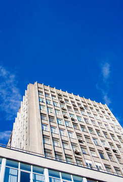 Urban building facade detail under clear blue sky