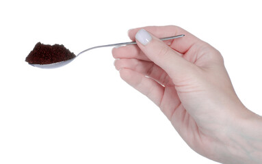 Hand holding spoon with ground coffee on white background isolation