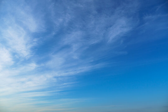 bright blue sky with clouds as abstract background