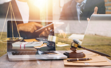 Justice and law concept.Male judge in a courtroom with the gavel, working with, computer and...
