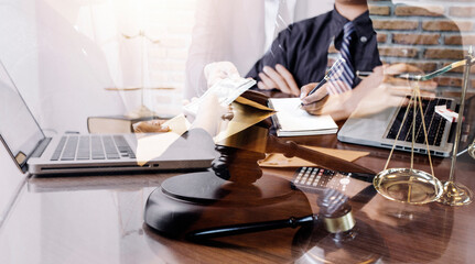 Justice and law concept.Male judge in a courtroom with the gavel, working with, computer and...