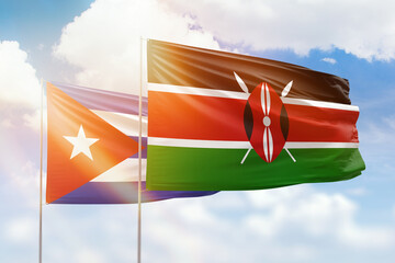 Sunny blue sky and flags of kenya and cuba